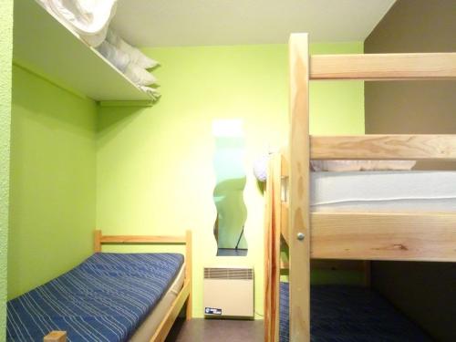 deux lits superposés dans une chambre aux murs verts dans l'établissement Studio au pied des pistes pour 5 personnes avec balcon et casier à skis - FR-1-602-10, à Arette