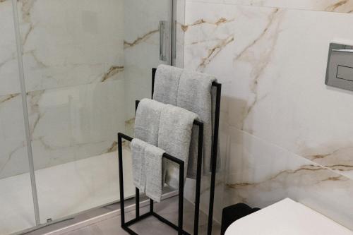 a bathroom with two towels on a towel rack at Fish Village Terrace Luxo in Vila Nova de Gaia