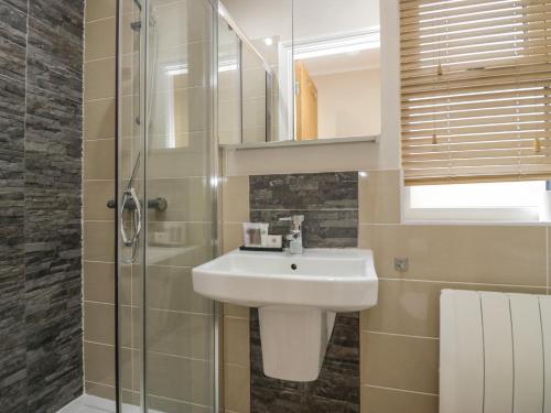 a bathroom with a sink and a shower at 8 Woodlands in Ulverston