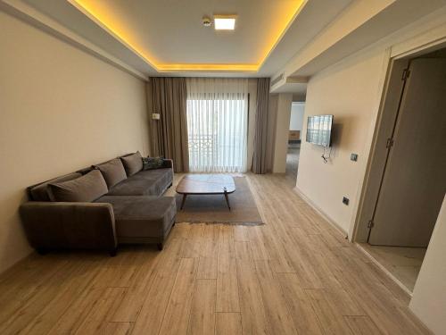a living room with a couch and a table at Nova Butik Hotel Çeşme in Cesme