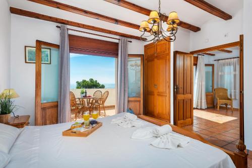 a bedroom with a bed with a view of the ocean at Villa Diego - PlusHolidays in Benissa