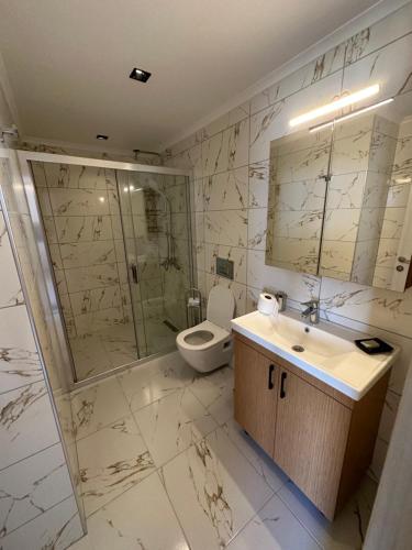 a bathroom with a sink and a shower and a toilet at Nova Butik Hotel Çeşme in Cesme
