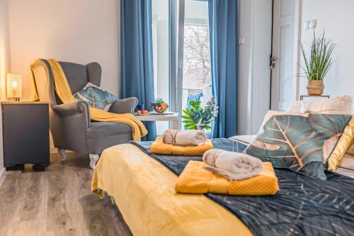 a bedroom with two beds with towels on them at Villa Santorini in Konarzyny