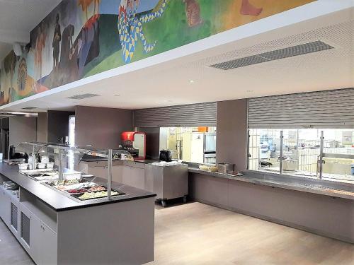 a restaurant kitchen with a counter with food on it at Stadthotel Hollabrunn in Hollabrunn