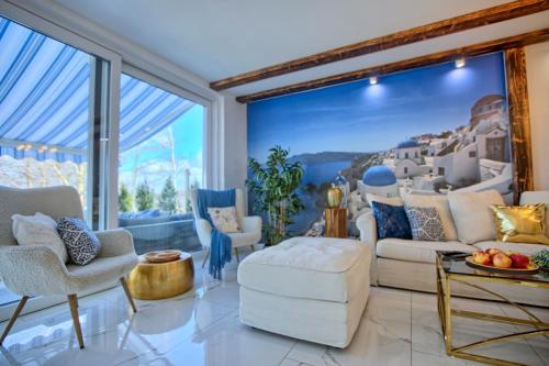 a living room filled with furniture and a large window at Villa Santorini in Konarzyny