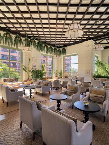 a lobby with couches and tables and windows at H10 Costa Adeje Palace in Adeje