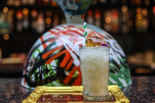 a drink sitting on a table with a plate at The Quba Boutique Hotel Pattaya in Pattaya Central