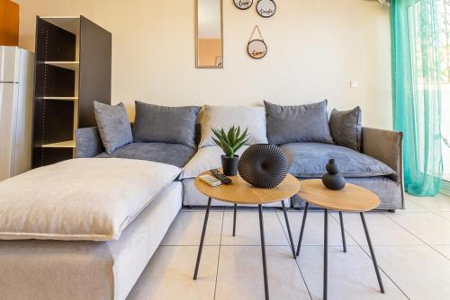 un salon avec un canapé et deux tables dans l'établissement Stay Fly, à Kavala