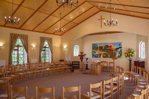 a room with rows of tables and chairs in a church at The Volmoed Trust in Hermanus