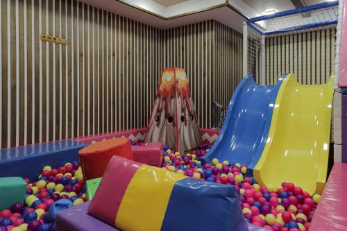 a play room with a bunch of balls and a slide at President Hotel&Restaurant&SPA in Trostyanets