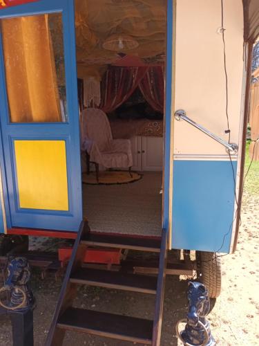 a door to a tiny house with a ladder at Git'an Périgord la Bonne aventure in Groléjac