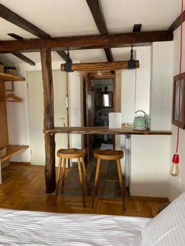 a kitchen with a table and two stools in a room at Lakeview Apartments Ohrid in Ohrid