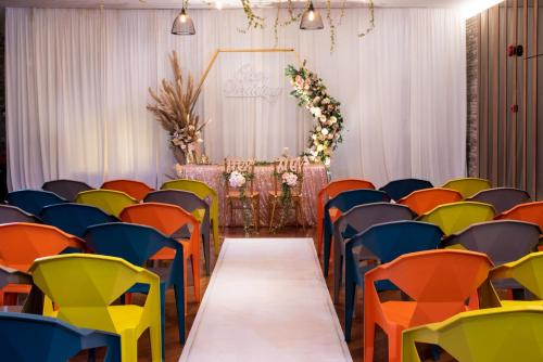 a wedding aisle with colorful chairs and a marquee at Olive Tree Hotel Penang in Bayan Lepas