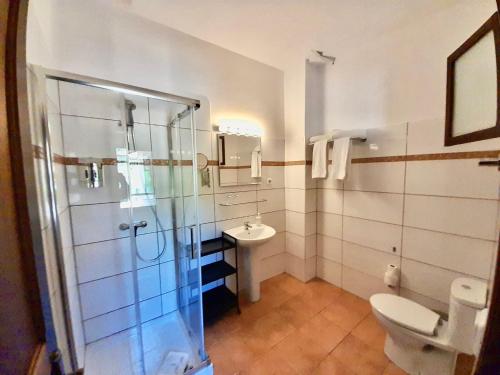 a bathroom with a shower and a toilet and a sink at Sol Port Soller in Port de Soller