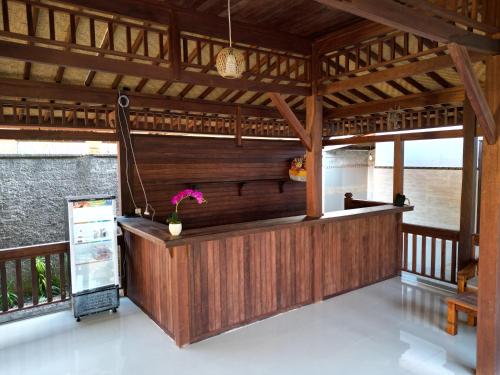 a bar in a wooden building with at Villa Vilah in Nusa Penida