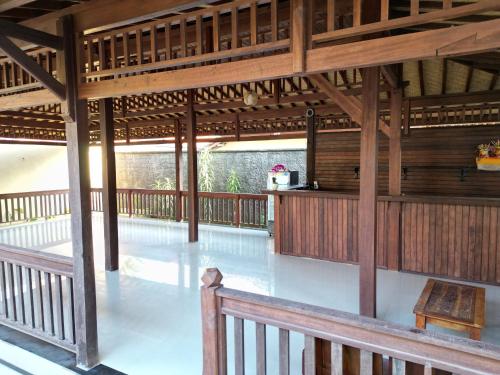 a wooden pavilion with a bench and a table at Villa Vilah in Nusa Penida