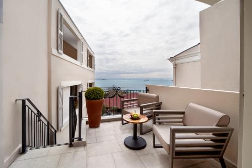 a balcony with chairs and a table on a building at Mula Hotel in Istanbul