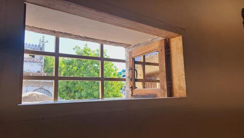an open window in a room with a view at Sufi Khandar Home Stay in New Delhi