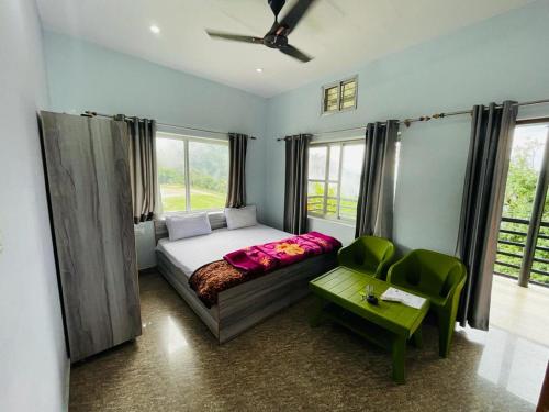 a bedroom with a bed and a chair and window at Sports Homestay in Lansdowne