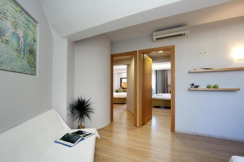 a living room with a couch and a table at Hotel Lefkas in Lefkada Town