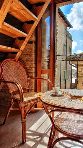 eine Terrasse mit 2 Stühlen und einem Tisch auf der Veranda in der Unterkunft Chiocciola in Offida
