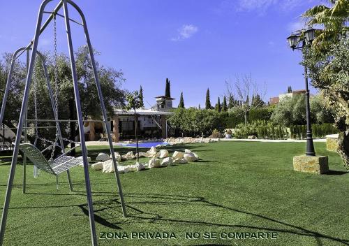 un columpio en un parque con parque infantil en Villa Capricho de Luna, en Caparacena