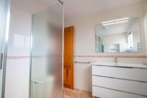 a bathroom with a sink and a mirror at Villa Corina - Plusholidays in Ifach