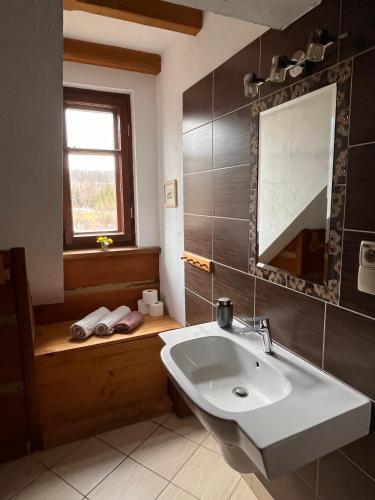 a bathroom with a sink and a window and a tub at Chata Wetłyna I in Wetlina