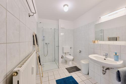 a bathroom with a shower toilet and a sink at Ferienwohnung Sonnendeck Moba-Travel in Priwall