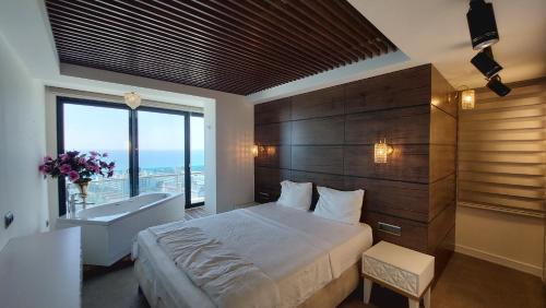 コナクリにあるElite Admiral Premium Residencesのベッドルーム(大型ベッド1台、大きな窓付)