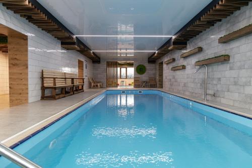 a swimming pool with blue water in a building at President Hotel&Restaurant&SPA in Trostyanets