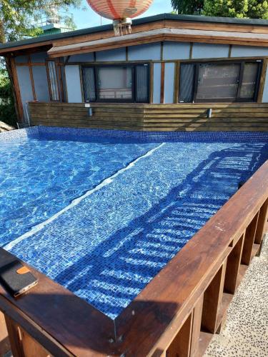 a swimming pool in front of a house at Jiang's B&B 江院子庭園民宿 in Jian