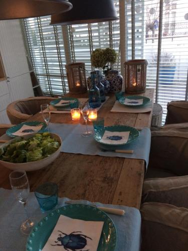 a wooden table with plates of food on it at Playa Baltis Apartamenty Club di Mare in Międzyzdroje