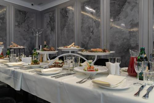 a long table with plates of food on it at President Hotel&Restaurant&SPA in Trostyanets