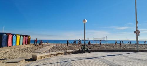 a group of people on a beach with the ocean at La guarida rústica del zorro in Jijona