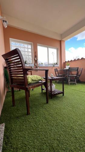 a room with two chairs and a table and a green carpet at Casa Sabry in Olbia