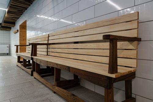 a row of wooden benches in a room at President Hotel&Restaurant&SPA in Trostyanets