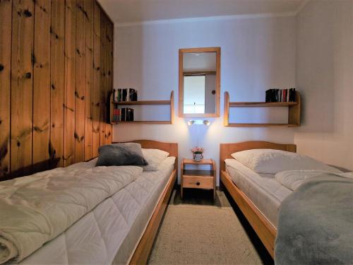 1 dormitorio con 2 camas y espejo en la pared en Ferienpark F03-004 Ferienpark, en Heiligenhafen