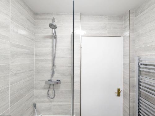 a shower with a shower head in a bathroom at Cissa in Chichester