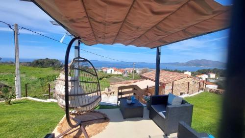 a view from the porch of a house with a swing at Tía Amalia - Con vistas al mar in Carnota
