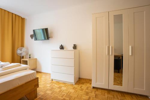a bedroom with a bed and a dresser with a mirror at Central living - Stephansdom Apartments in Vienna
