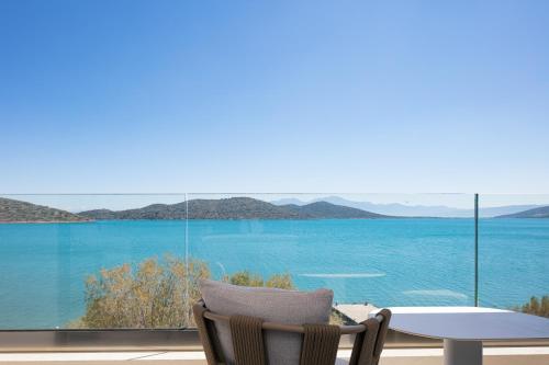 a room with a table and a view of the ocean at Naiades Boutique Hotel - Adults Only in Elounda