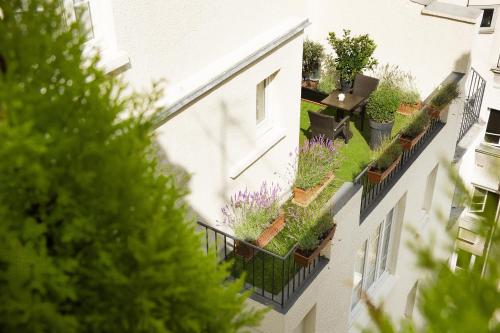 an apartment building with plants on the side of it at Hotel Residence Foch in Paris