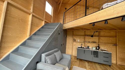 a staircase in a room with a chair and a desk at Dumbo Eco Camp in Ozurgetʼi