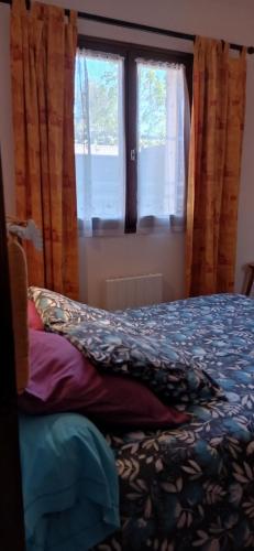a bedroom with a bed and a window at Au coeur de la Provence Verte in Le Cannet-des-Maures