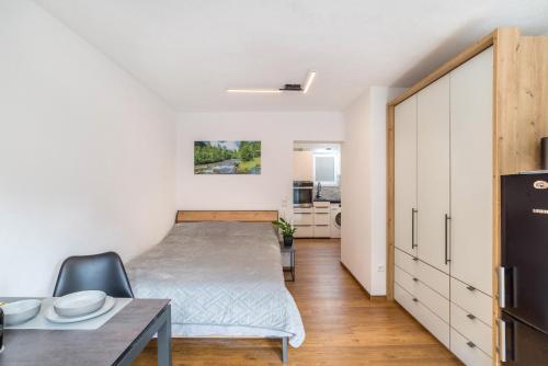 a small bedroom with a bed and a table at Ferienwohnung Rennbächle in Bad Wildbad