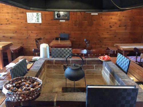 a dining room with a table and a tea pot at 『一軒丸々貸切』徒歩5分圏内カフェ 自然を満喫 Modern Ski Chalet +WiFi & 5min walk to cafes. in Nagano