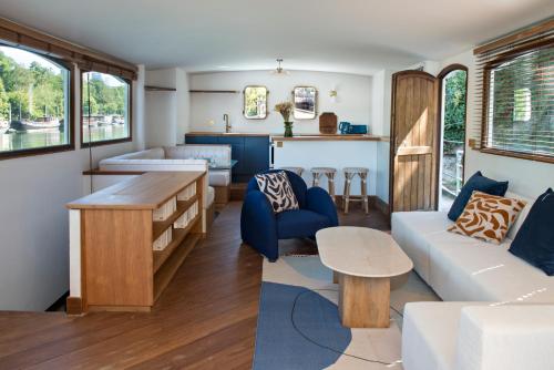 a living room with a couch and a table at Escale Sur Seine in Paris