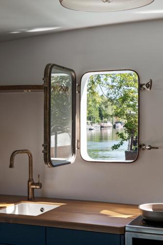 a kitchen with a sink and a window at Escale Sur Seine in Paris