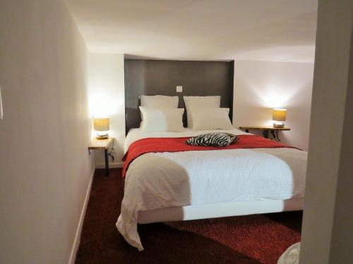 a bedroom with a large white bed with two lamps at Apartment RED LOFT Lyon Brotteaux-Part Dieu in Lyon